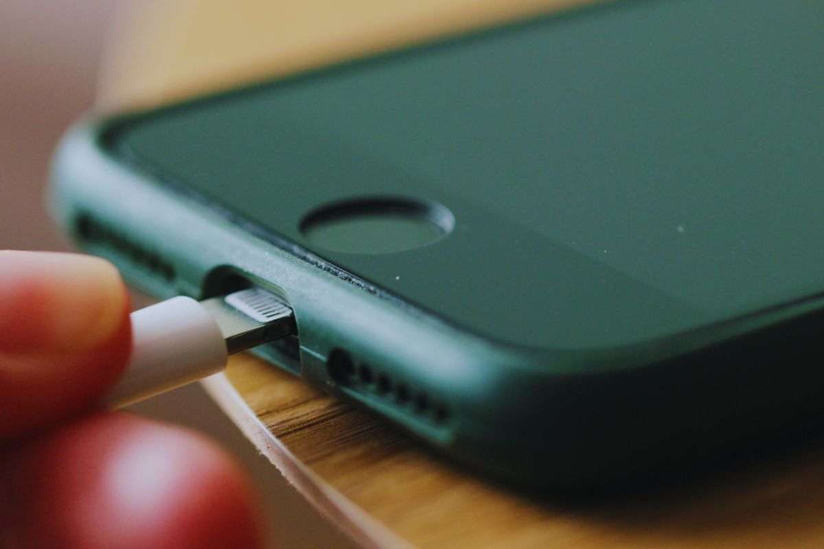 Persona che collega smartphone a cavo usb